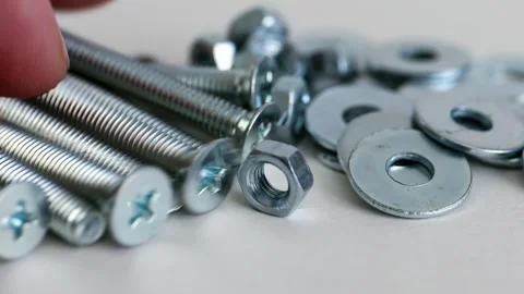 Machine Screws Nuts and Washers on White Background Close Up Hardware Set Stock Footage 333773826