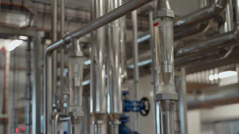 Machine setting in a factory with pipes. Pipe with liquid water inside Stock Footage 155522355