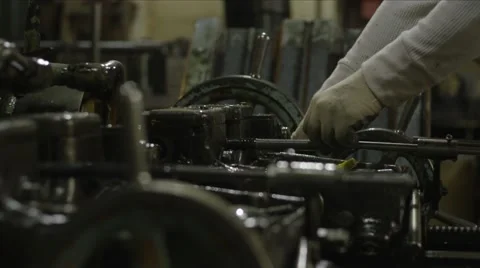 Machine Shop Threading Machine CU of Metal Wheels and Operator Hands Stock Footage 40935450