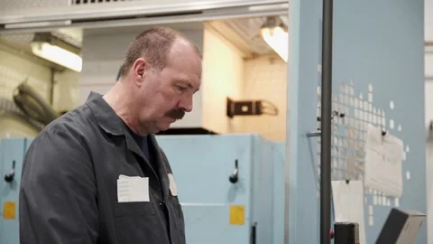 Machine shop worker using computer | Stock Video | Pond5