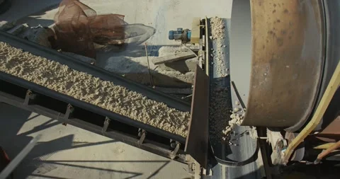 A machine for sifting sand (sorting) works in a concrete plant Stock Footage 277595791