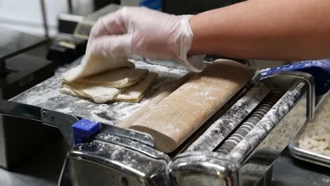 The machine is slicing the dough into many noodles Stock Footage 171360508