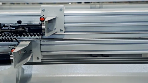 Machine sliding mechanical arm along metal beam Stock Footage 95487736