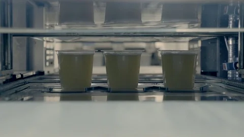 Machine in soup fatcory putting on the lid Stock Footage 78033245