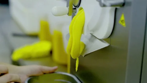 Machine spills yellow ice-cream Stock Footage 72249094