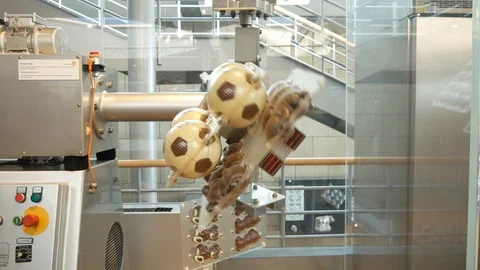 Machine spins moulds to coat them evenly with chocolate Stock Footage 88630268