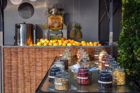 A machine for squeezing fruit juice and jar of delicious nuts and dried fruit Stock Photos