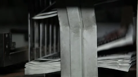 Machine stacking newspapers after being printed Stock Footage 57325306