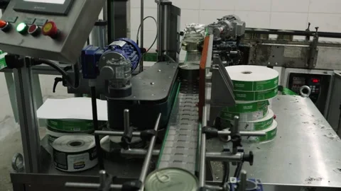 A machine that sticks labels on containers. Fresh Pork Manufacturing Plant. Stock Footage 251853114