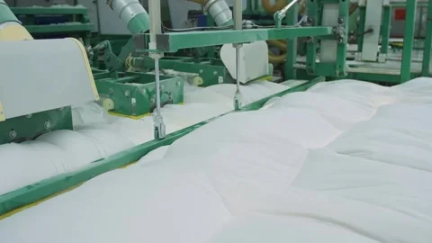 Machine stuffing down a blanket in a factory Stock Footage 279919404