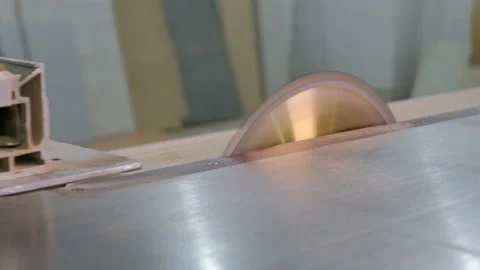Machine tool with a circular saw and the hands of a joiner close-up. Sawing off Stock Footage 116013048