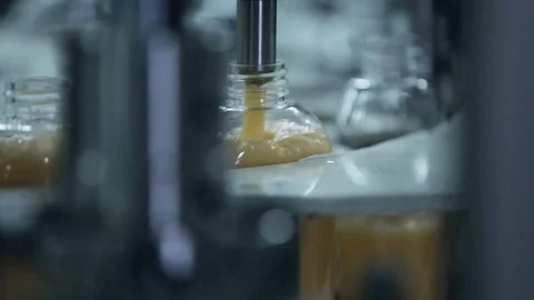 Machine tool pours liquid into the bottle Stock Footage 75780948