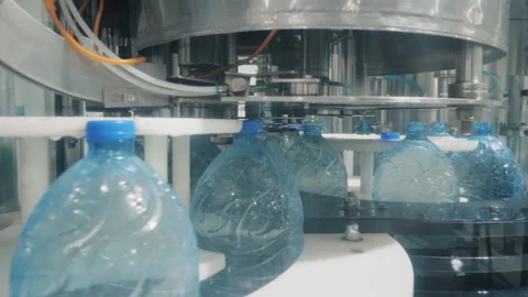 Machine tool puts caps on bottles with water in workshop Stock Footage 160713915