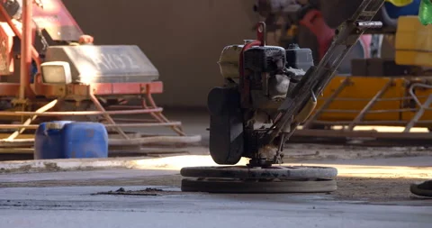 Machine trowel with an operator is used for grinding the cement surface Stock Footage 147636643