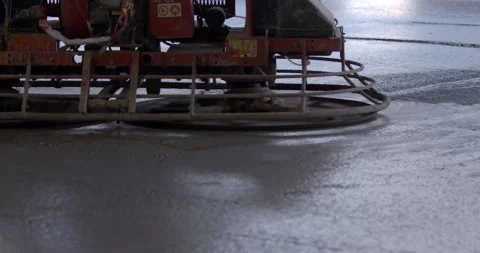 Machine trowel with an operator is used for grinding the cement surface Stock Footage 147637381