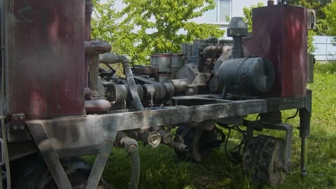 Machine used for drilling water wells in open area near building Stock Footage 336792476