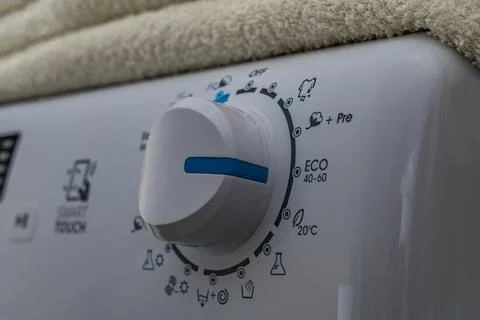 Machine wash, eco-friendly program, saving energy and water, thermostat kno.. Stock Photos