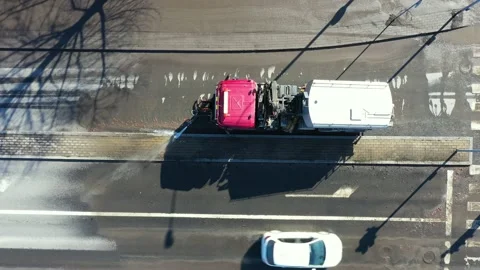 The machine is washing the street in spring after winter. Stockbeeldmateriaal 138434147