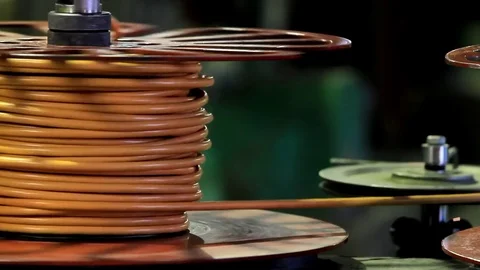 The machine winds the orange wire onto the reel Video stock 76951081