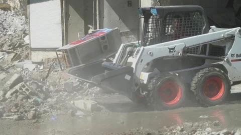 Machine working to clear rubble from streets of Raqqah, Syria Stock Footage 94565385