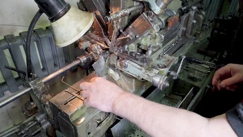 The machine in the workshop cuts a piece of steel wire on the go. Stock Footage 117224439