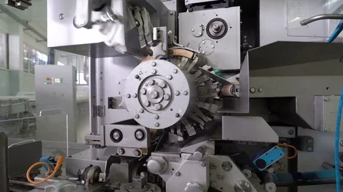 The machine wraps the candy. Confectionery factory. Sweets move along the Stock Footage 74187639