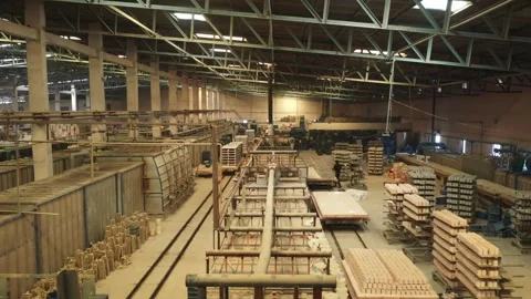 Machinery of ceramic mugs stacked under a large steel-trussed warehouse roof. Stock Footage 327805129