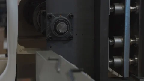 Machinery shop. Die cutting machine. Punching mechanism part moving, close up Stock Footage 93237452