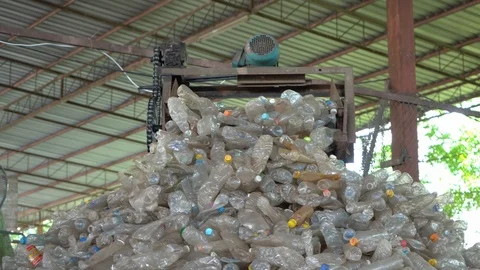 Machines are making separate plastic bottles for recycling in the factory. Stock Footage 111572902