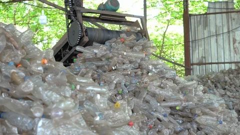 Machines are making separate plastic bottles for recycling in the factory. Stock Footage 111573402