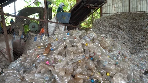 Machines are making separate plastic bottles for recycling in the factory. Stock Footage 111573561