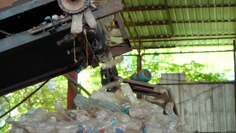 Machines are making separate plastic bottles for recycling in the factory. Stock Footage 111574105