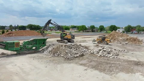 Machines Work on a Construction Site to Process Debris and Prepare Land for.. Stock Footage 337642256