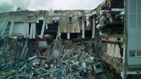 Machines work near building of old abandoned hockey arena Video stock 127745844