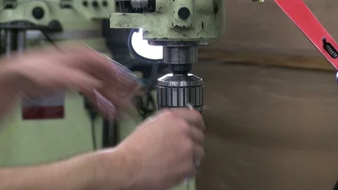 A machinist operates a drilling machine at a tooling shop- Close-up. Video stock 125867238