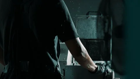 Machinist Operating Industrial Machine in Dark Workshop Stock Footage 337927417