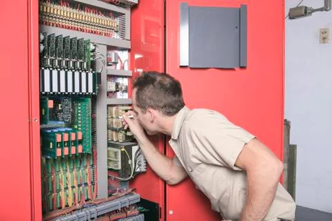 Machinist worker technicians at work adjusting lift with spanner Foto stock