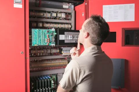 Machinist worker technicians at work adjusting lift with spanner Stock-Fotos