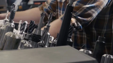 Machinist working through drill bits Stock Footage 103336036