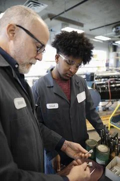 Machinists working in factory Stock Photos