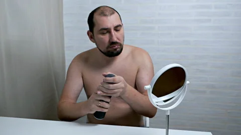 Macho applying shaving foam on face.White background. Slow motion Stock Footage 120134505