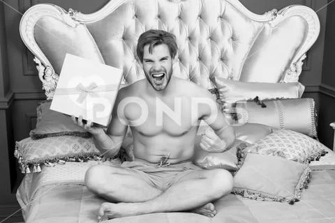 Macho in underwear shout angry with present box Stock Photos