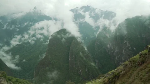 Machu Picchu | Cloudy Mountain Pan to Ruined City Stock Footage 83580621