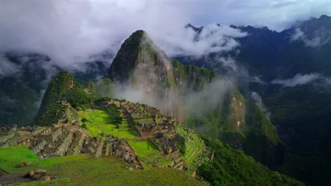 Machu Picchu Peru's Inca Temple low clouds fog layer sunny early morning Stock Footage 334116853
