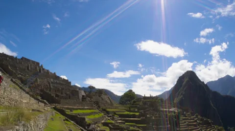 Machu Picchu wide angle in time lapse with clouds looking into Sun Stock Footage 33832541