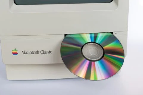 Macintosh Classic  with a floppy disk drive and a CD Stock Photos