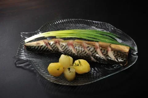 Mackerel on a plate in the form of fish Stock Photos