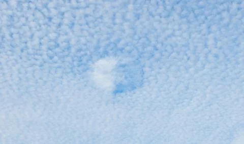 Mackerel sky clouds made up of rows of cirrocumulus or altocumulus clouds d.. Stock Photos