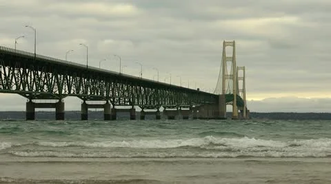 Mackinac Bridge - long shot as waves crash on shore Stock Footage 10832062