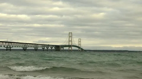 Mackinac Bridge - wide angle as waves crash on shore Stock Footage 10832006